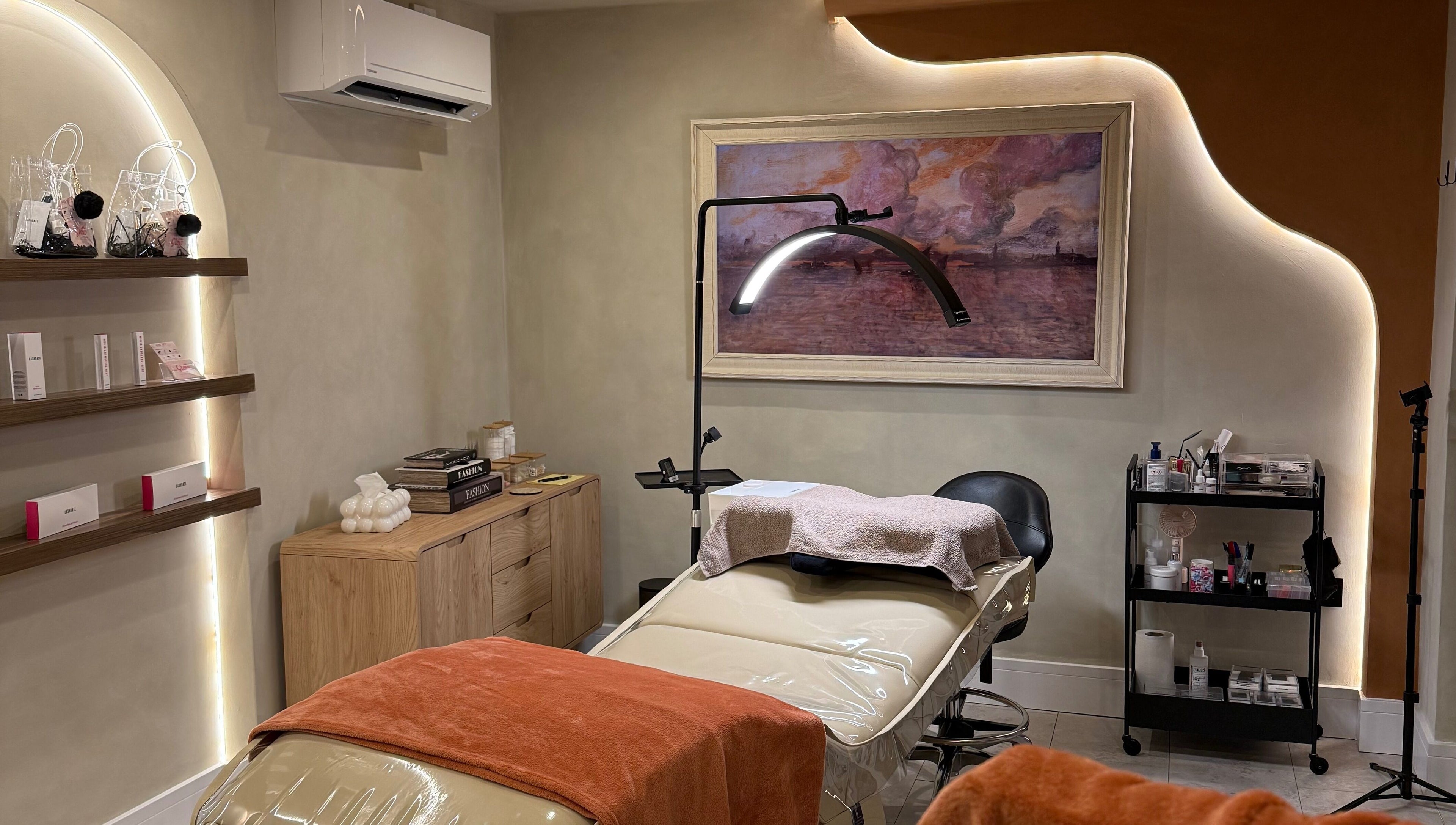 Relaxing treatment room at Glow By Clo in Aldershot, England, GB, featuring a plush massage bed and calming decor.
