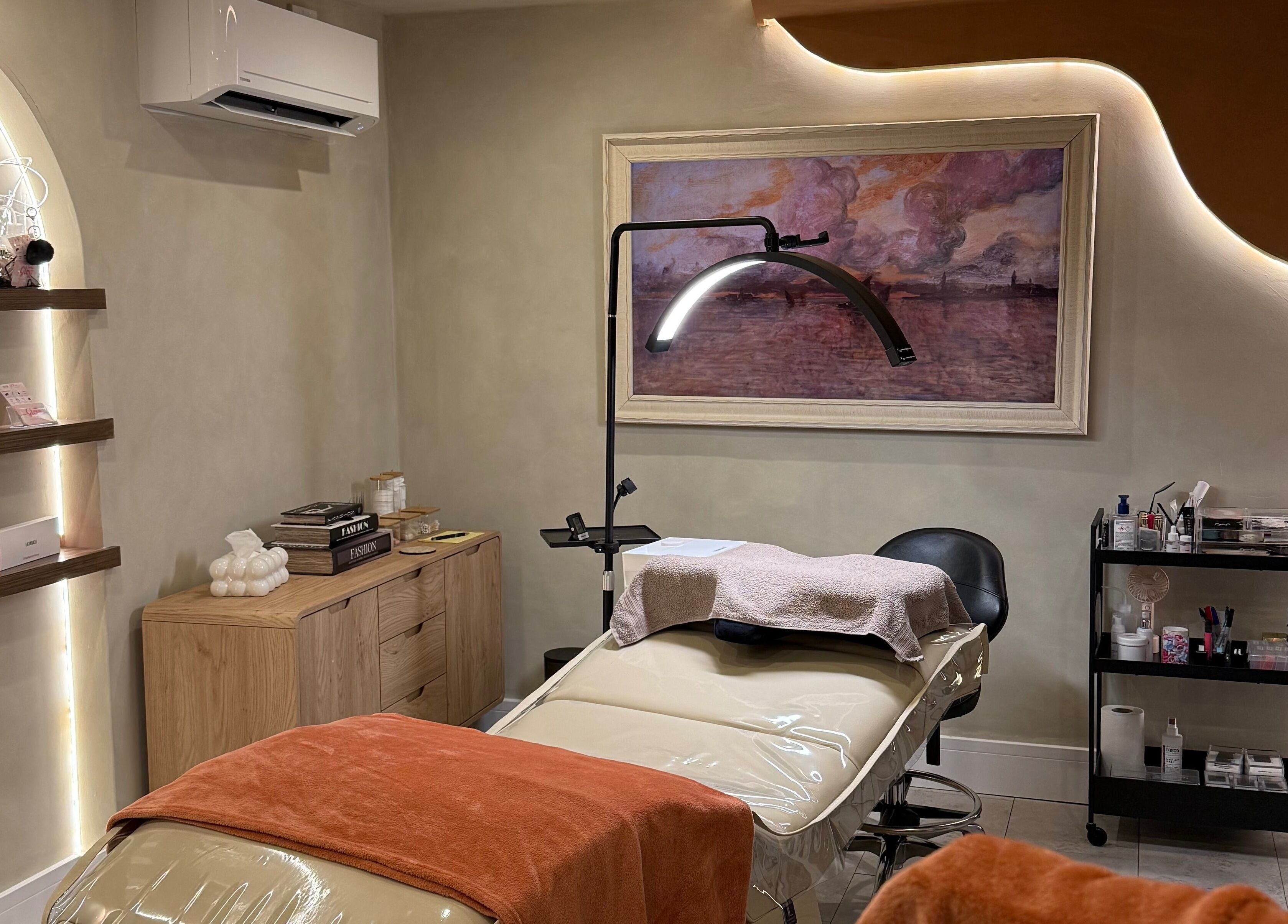 Relaxing treatment room at Glow By Clo in Aldershot, England, GB, featuring a plush massage bed and calming decor.