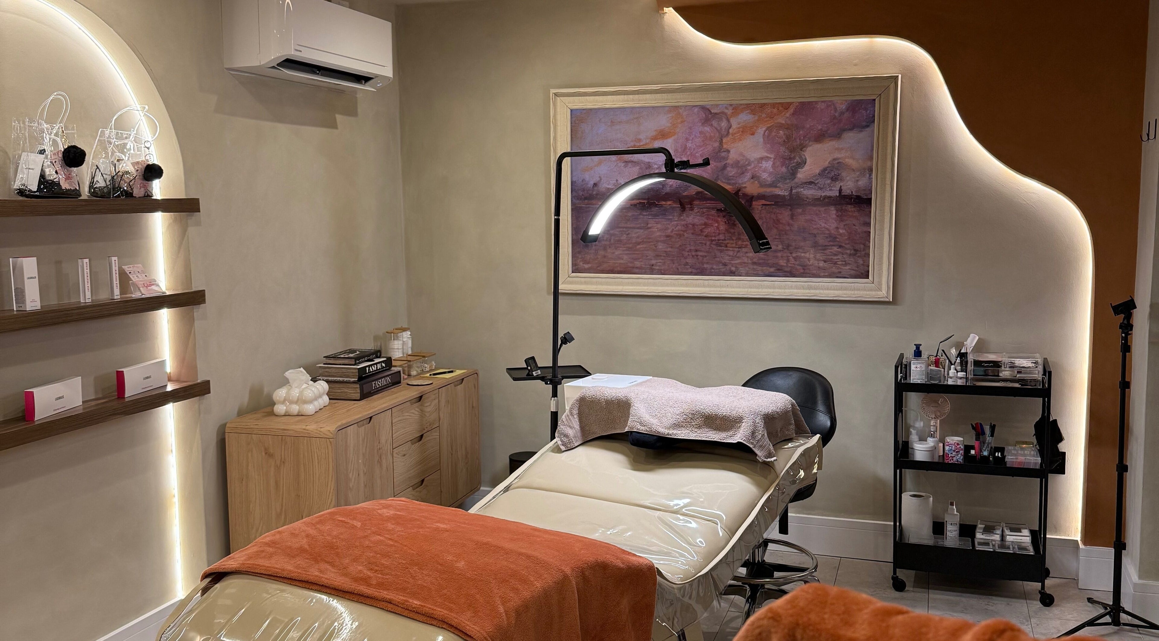 Relaxing treatment room at Glow By Clo in Aldershot, England, GB, featuring a plush massage bed and calming decor.