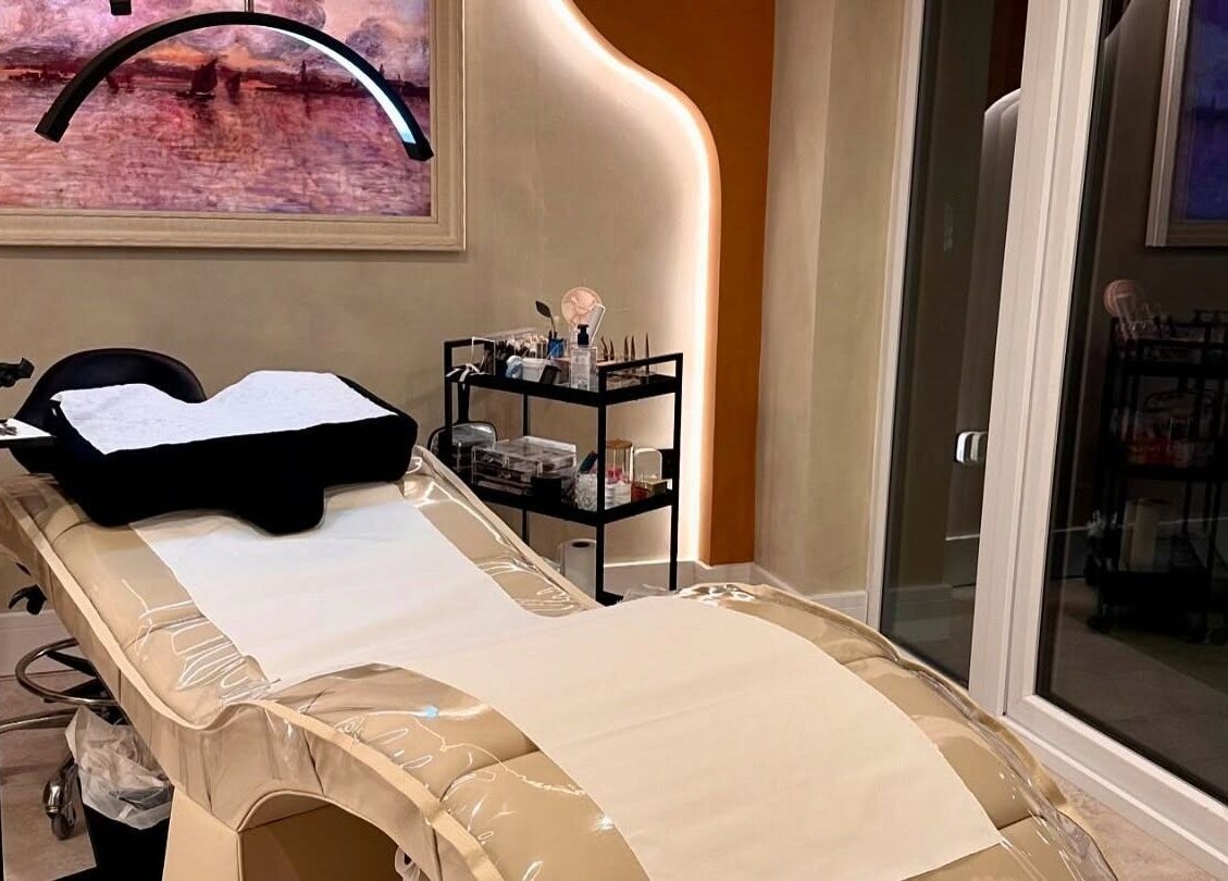 Relaxing treatment room at Glow By Clo in Aldershot, England, GB, featuring a modern spa bed and warm lighting.