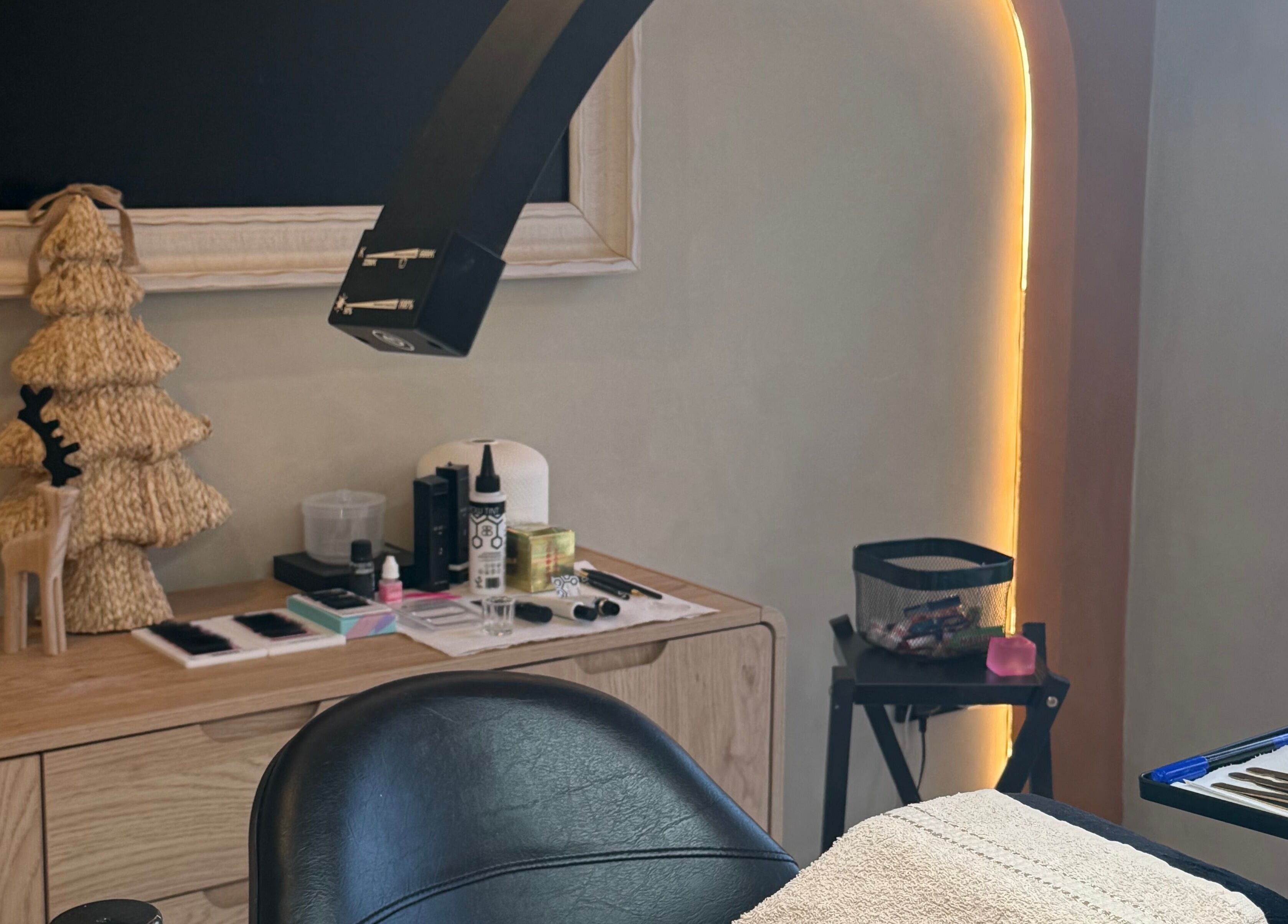 Cozy treatment room at Glow By Clo, Aldershot, England, GB, featuring elegant decor and beauty tools.