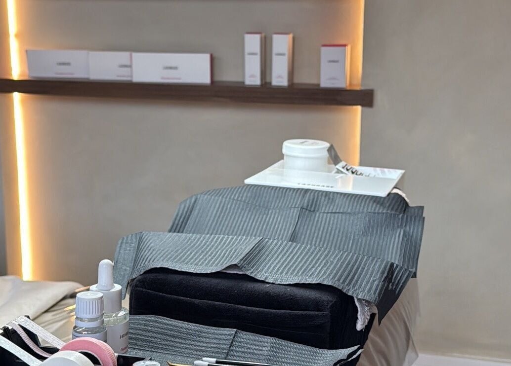 Relaxing spa treatment setup at Glow By Clo, Aldershot, England, GB with skincare products and ambient lighting.