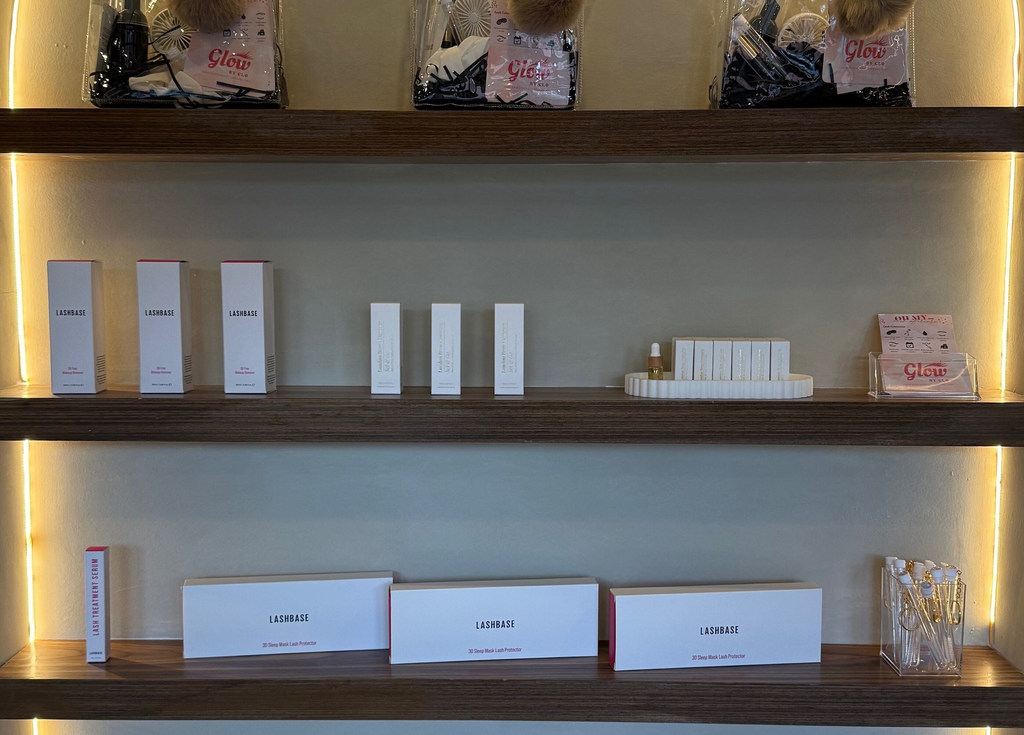 Product display shelves at Glow By Clo, Aldershot, England, GB lit with soft ambient lighting.