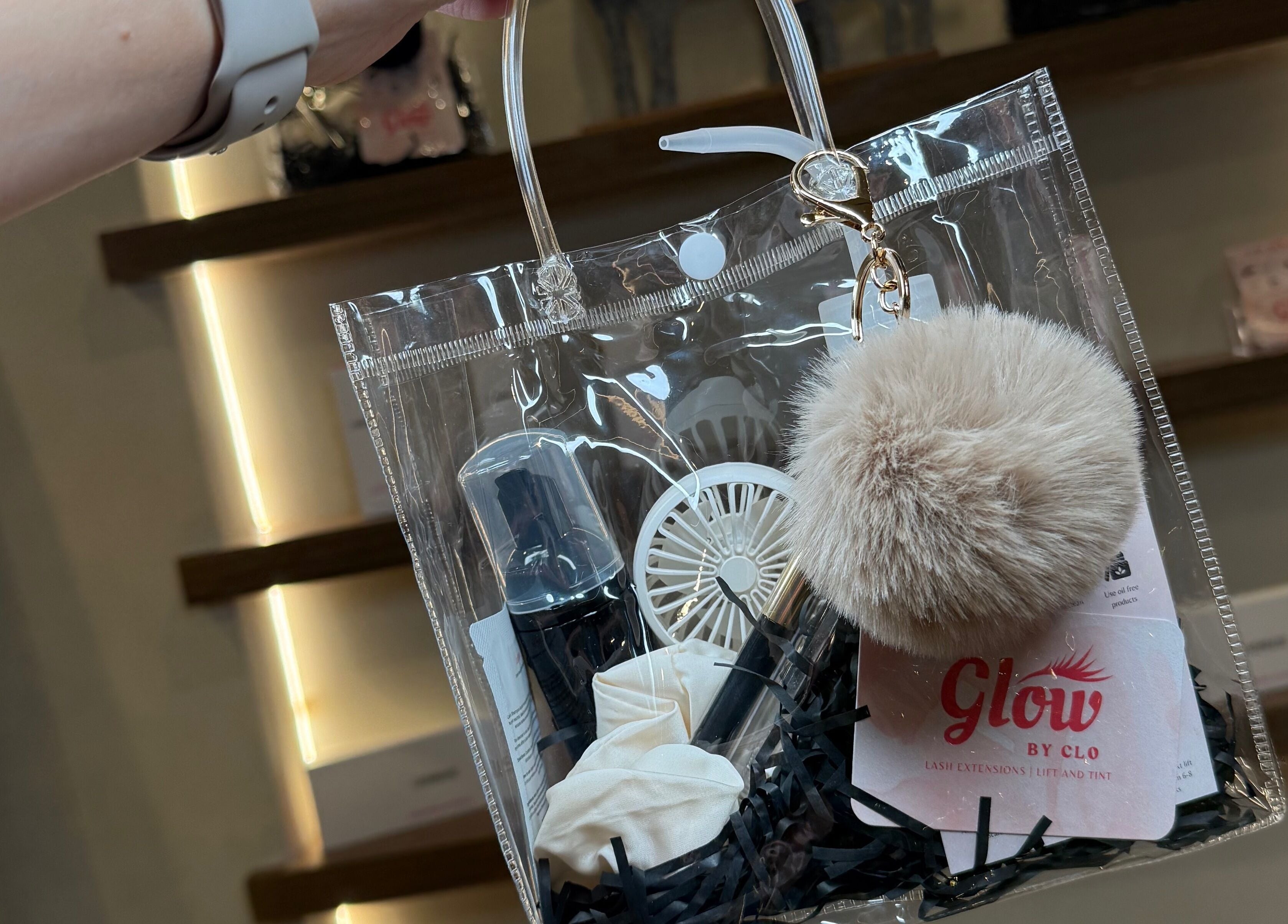 Transparent tote with beauty items from Glow By Clo, Aldershot, England, GB, showcasing elegant packaging.
