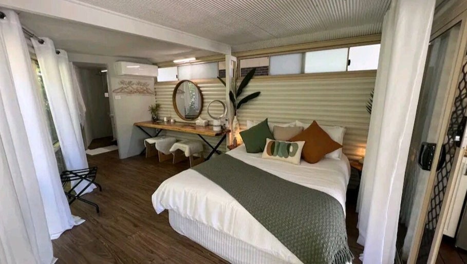 Cozy bedroom at Essenc8 Relaxation Massage in Cawarral, Queensland, AU, featuring modern decor and natural light.