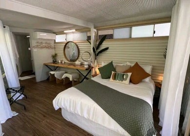 Cozy bedroom at Essenc8 Relaxation Massage in Cawarral, Queensland, AU, featuring modern decor and natural light.
