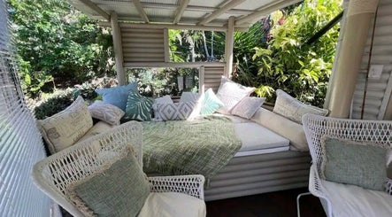 Outdoor relaxation lounge at Essenc8 Relaxation Massage in Cawarral, Queensland, AU, with cozy pillows and greenery.