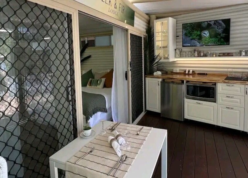 Interior of Essenc8 Relaxation Massage in Cawarral, Queensland, AU, featuring a cozy seating area and kitchenette.