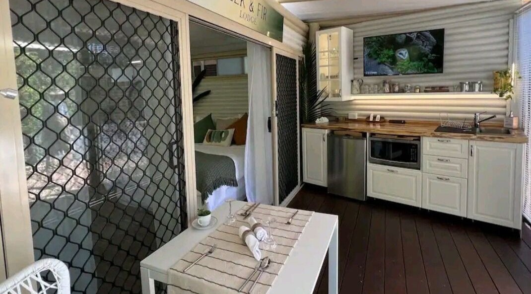 Interior of Essenc8 Relaxation Massage in Cawarral, Queensland, AU, featuring a cozy seating area and kitchenette.