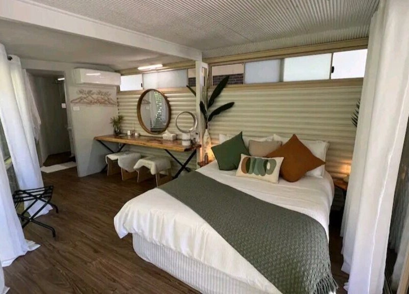 Serene bedroom at Essenc8 Relaxation Massage in Cawarral, Queensland, AU, featuring cozy bed and stylish decor.