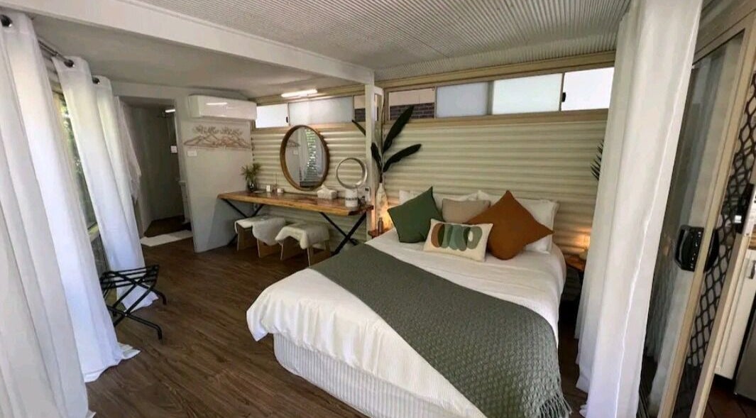 Serene bedroom at Essenc8 Relaxation Massage in Cawarral, Queensland, AU, featuring cozy bed and stylish decor.