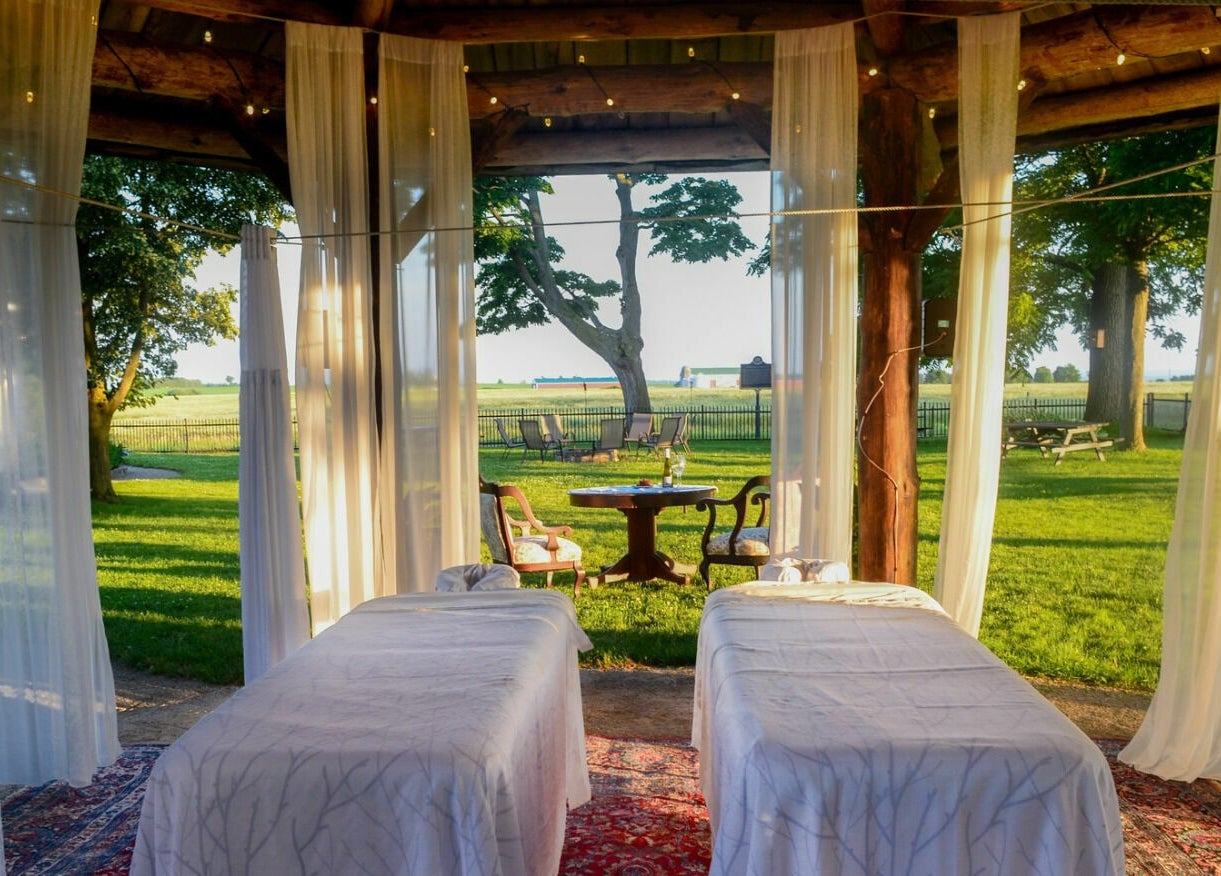 Outdoor relaxation area at Harvest Spa Stevenson Inn and Spa, Ontario, Ontario, CA with views of lush greenery.