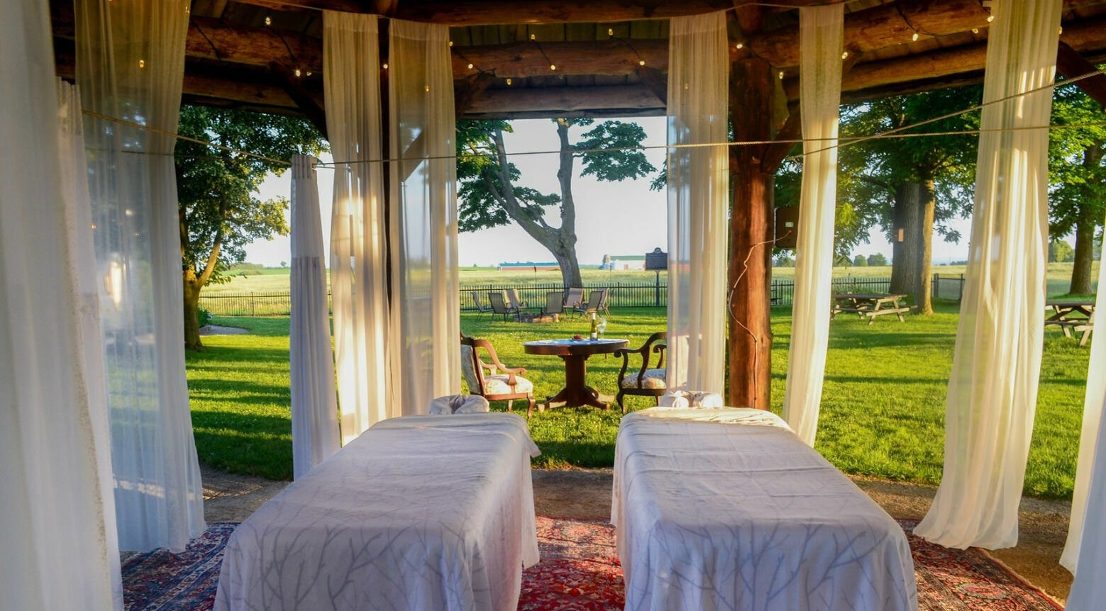 Outdoor relaxation area at Harvest Spa Stevenson Inn and Spa, Ontario, Ontario, CA with views of lush greenery.