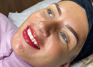 Smiling client showcases fresh permanent makeup at Jade Brennan Permanent Makeup, Cambridge, England, GB.