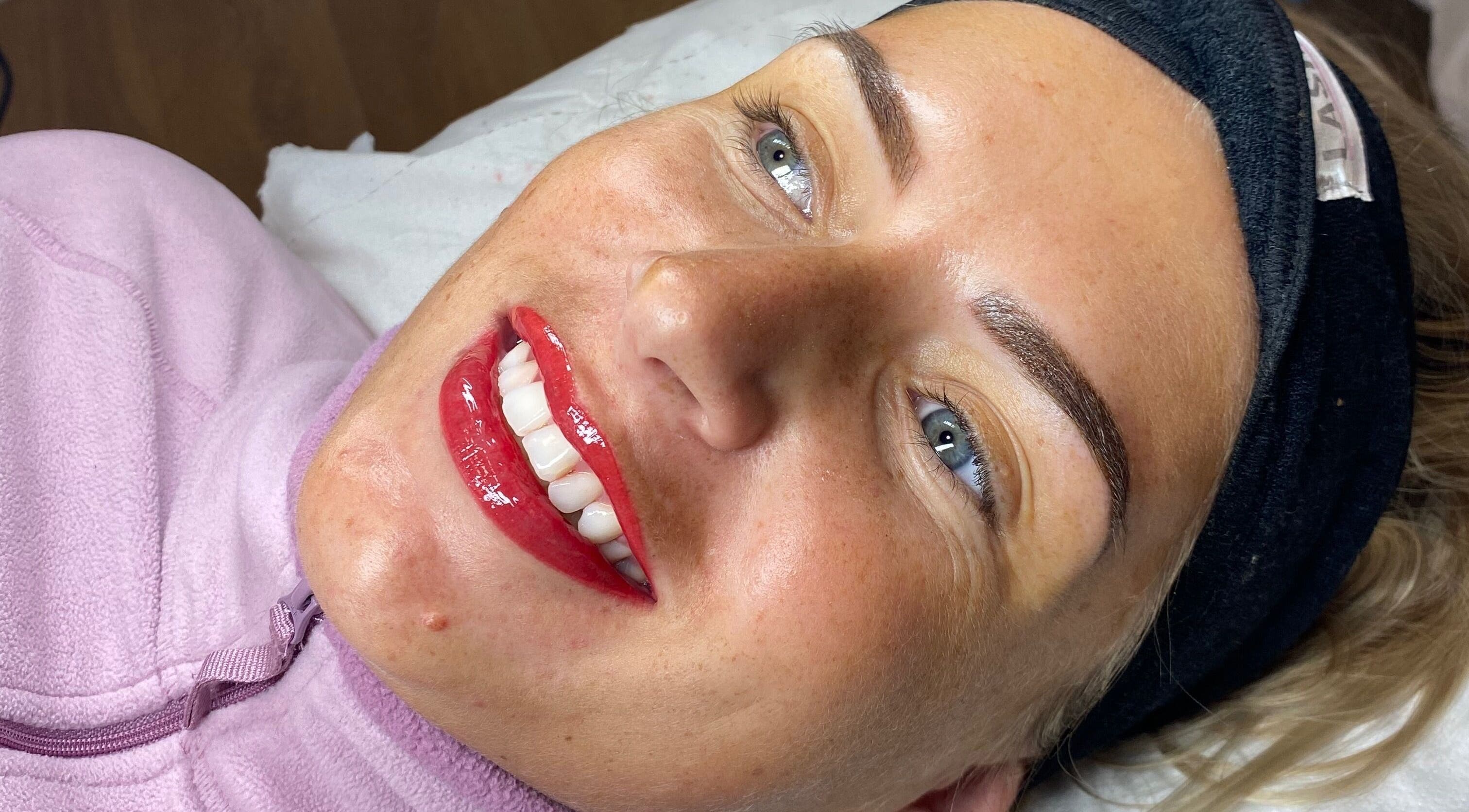Smiling client showcases fresh permanent makeup at Jade Brennan Permanent Makeup, Cambridge, England, GB.
