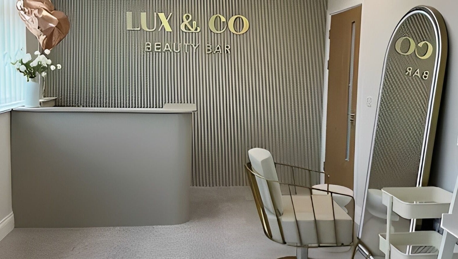 Chic reception at Lux&co Beauty Bar, Cardiff, Wales, GB featuring stylish decor and modern seating.
