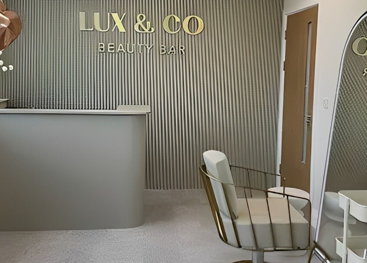 Chic reception at Lux&co Beauty Bar, Cardiff, Wales, GB featuring stylish decor and modern seating.