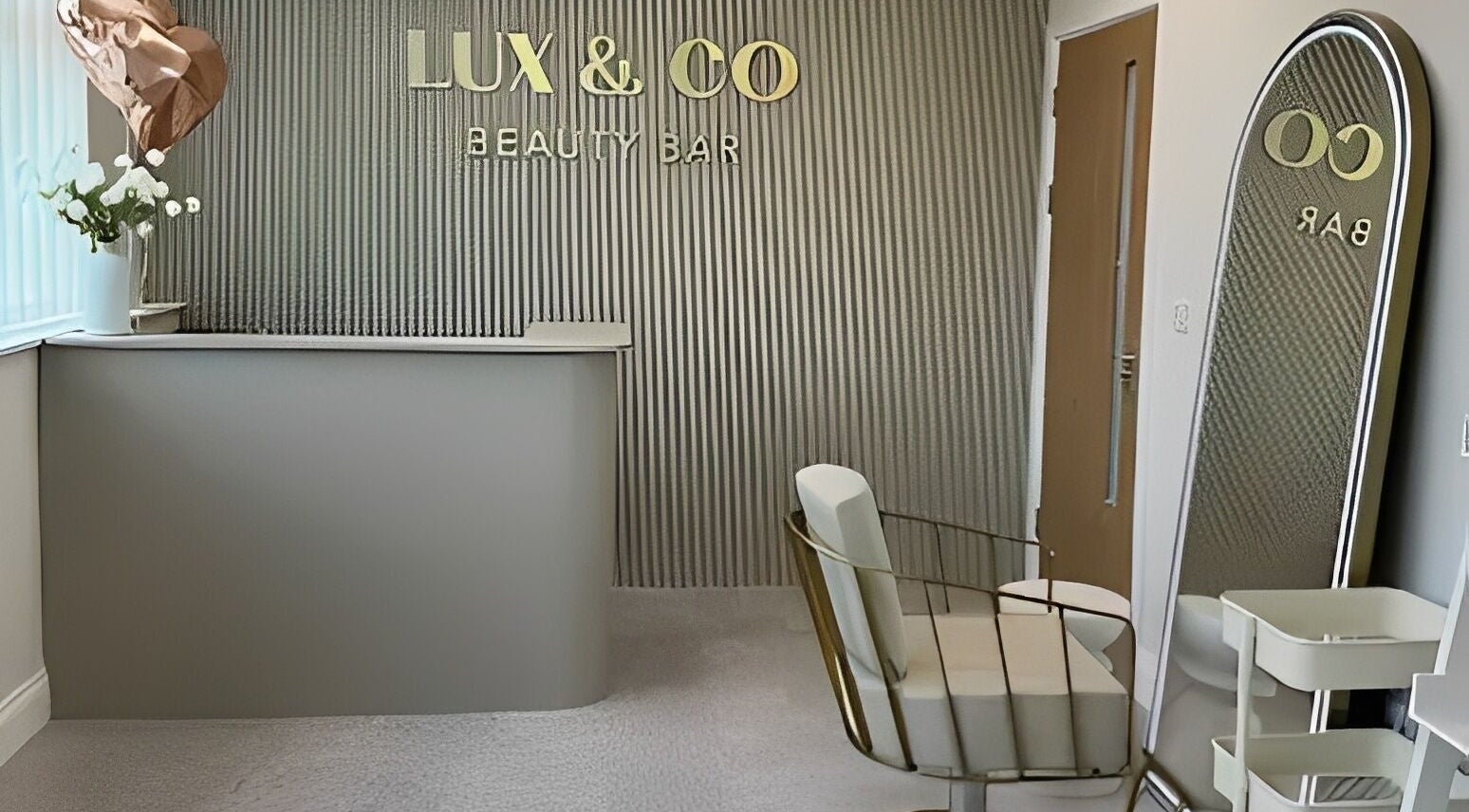 Chic reception at Lux&co Beauty Bar, Cardiff, Wales, GB featuring stylish decor and modern seating.