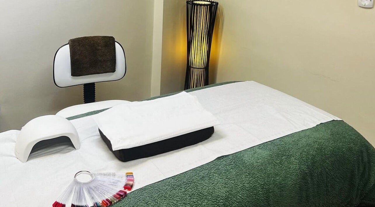 Relaxing treatment room at The Haven Beauty Room - Midhurst, Midhurst, England, GB. Green and white soothing decor.