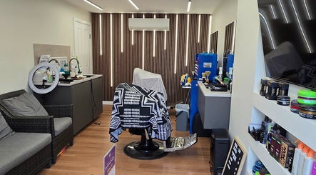 Modern interior of 2K Cuts Barbershop in West Hoxton, New South Wales, featuring stylish decor and amenities.