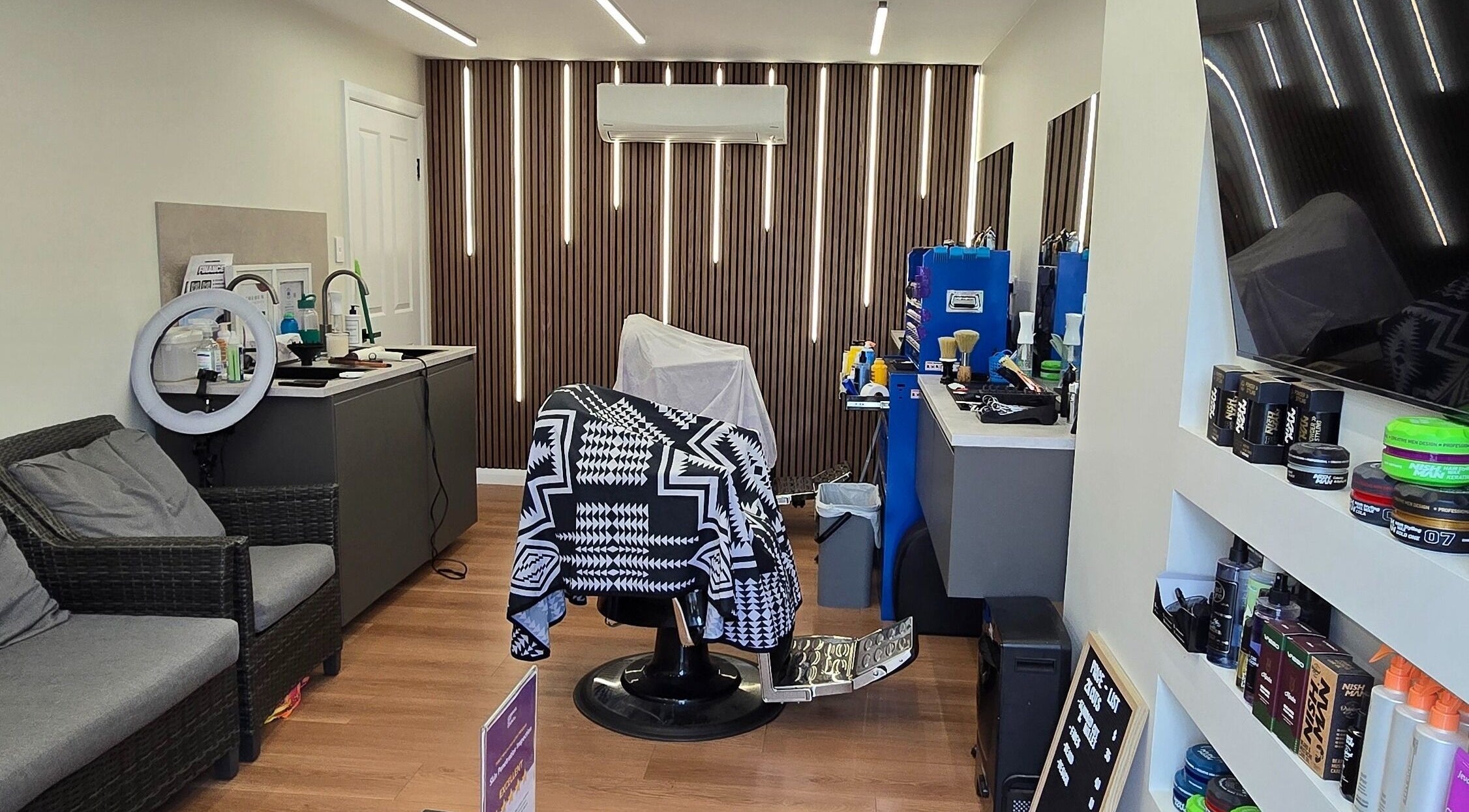 Interior of 2K Cuts Barbershop in West Hoxton, NSW, showcasing stylish barber setup and modern decor.
