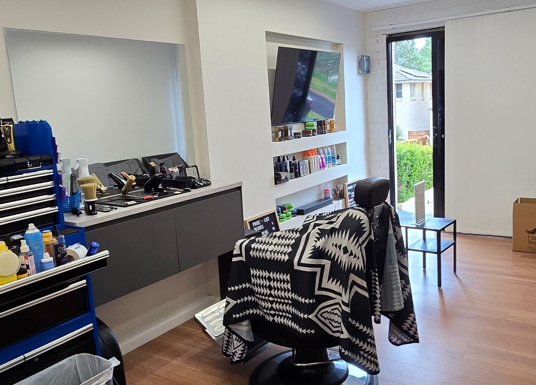 Modern interior of 2K Cuts Barbershop in West Hoxton, New South Wales, AU, showcasing stylish barber chair and tools.