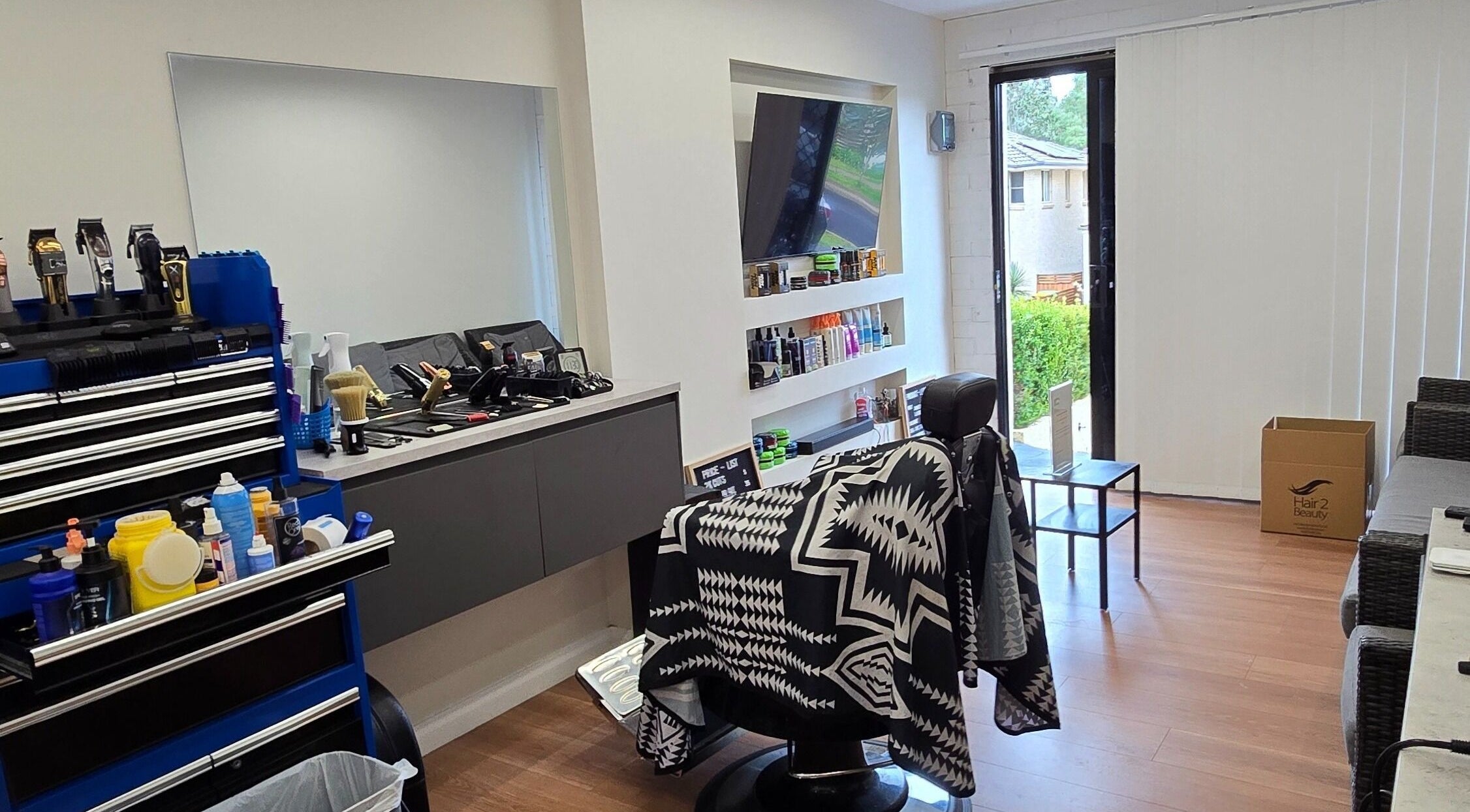 Modern interior of 2K Cuts Barbershop in West Hoxton, New South Wales, AU, showcasing stylish barber chair and tools.