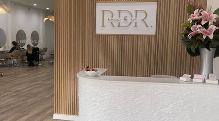 Reception area of Shh Beauty Secrets in Croydon, Victoria, AU with sleek decor and pink lilies.