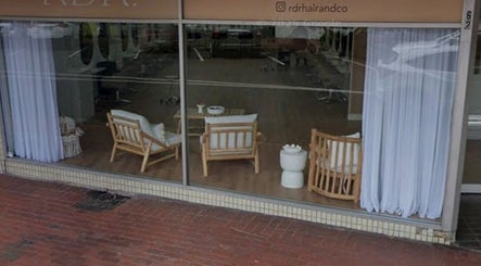 Relaxing lounge at Shh Beauty Secrets, Croydon, Victoria, AU with cozy wooden chairs and curtains.