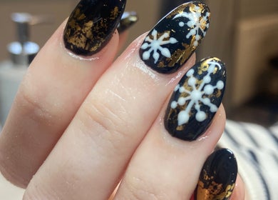 Stunning snowflake nail art at Nail Care by Claire in Tenterden, England, GB. Perfect for winter elegance.