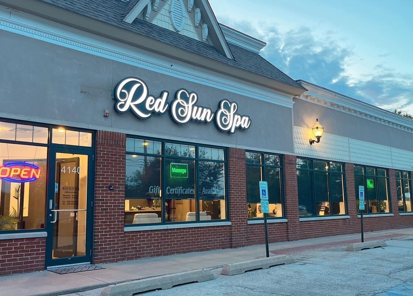 Exterior view of Red Sun Spa in Naperville, Illinois, US, showcasing welcoming entrance with glowing signs.