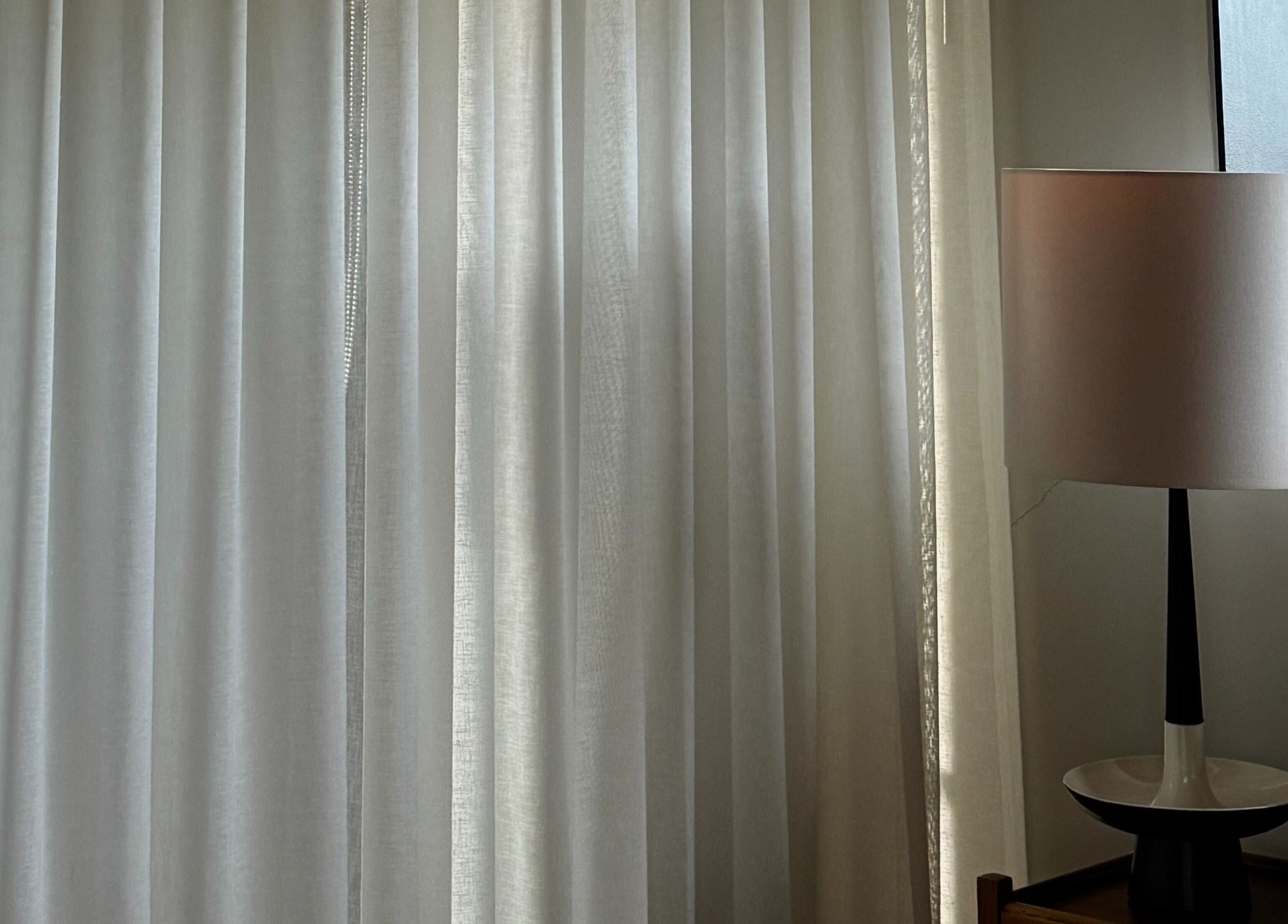 Modern lamp beside elegant drapes at Framework by miranda - Cottesloe Studio, Cottesloe, Western Australia, AU.