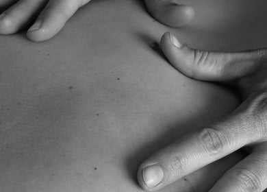Hands performing a massage at The Green Parrot Clinic, Swaffham, England, GB, showcasing expertise in wellness.