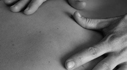 Hands performing a massage at The Green Parrot Clinic, Swaffham, England, GB, showcasing expertise in wellness.