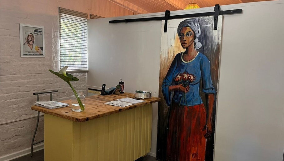 Reception desk at Mist Spa, Misty Mountain Reserve with vibrant art, Garden Route, Eastern Cape, ZA.