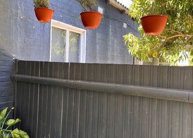 Hanging plants and wooden fence at Mist Spa, Misty Mountain Reserve, Garden Route, Eastern Cape, ZA.