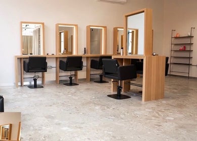 Spacious beauty studio at Amber Grace Artistry, Sheffield, England, GB, with sleek chairs and vanity mirrors.