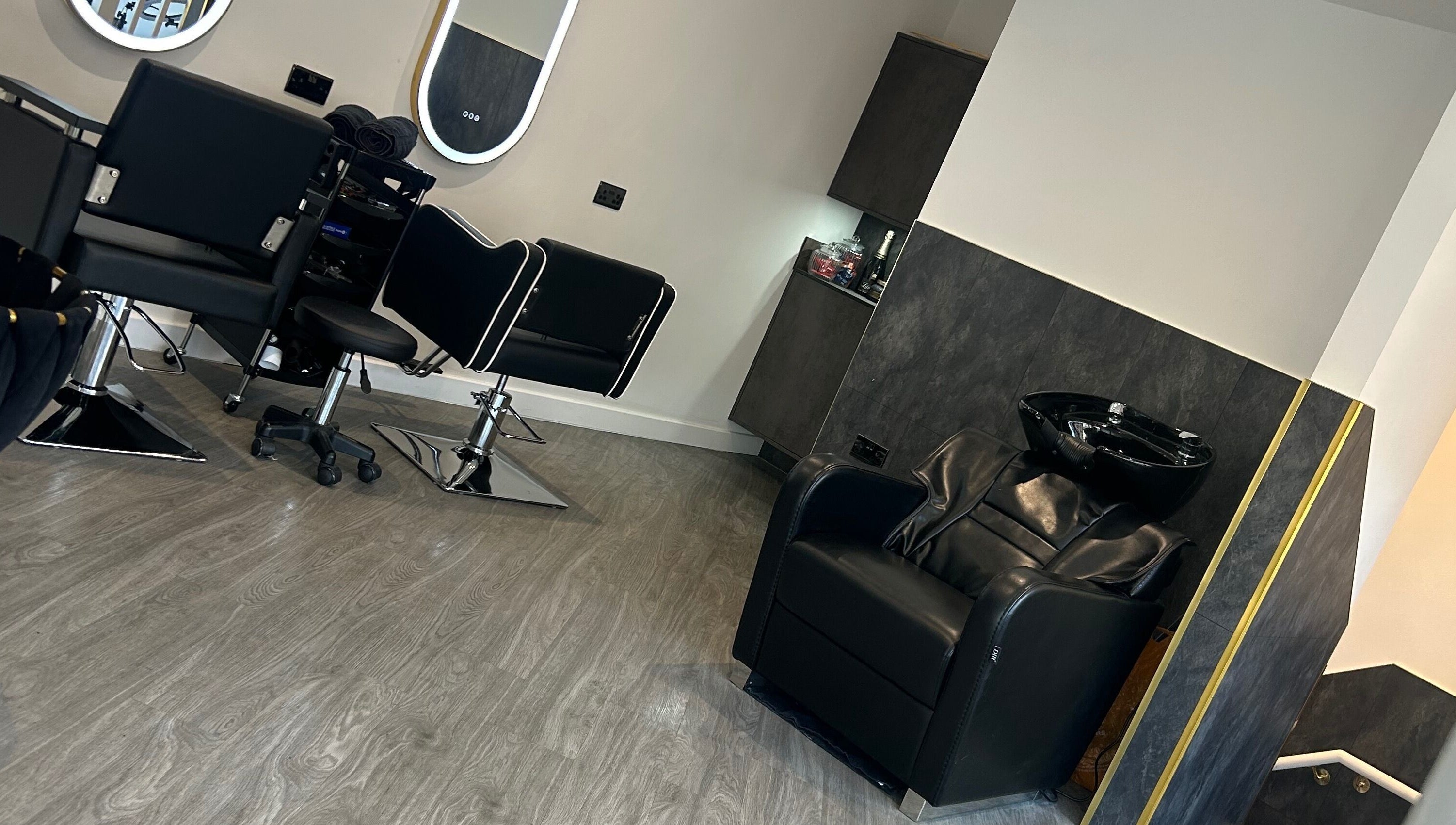 Modern salon interior at By Via, Blackpool, England, GB with stylish chairs and a hair washing station.