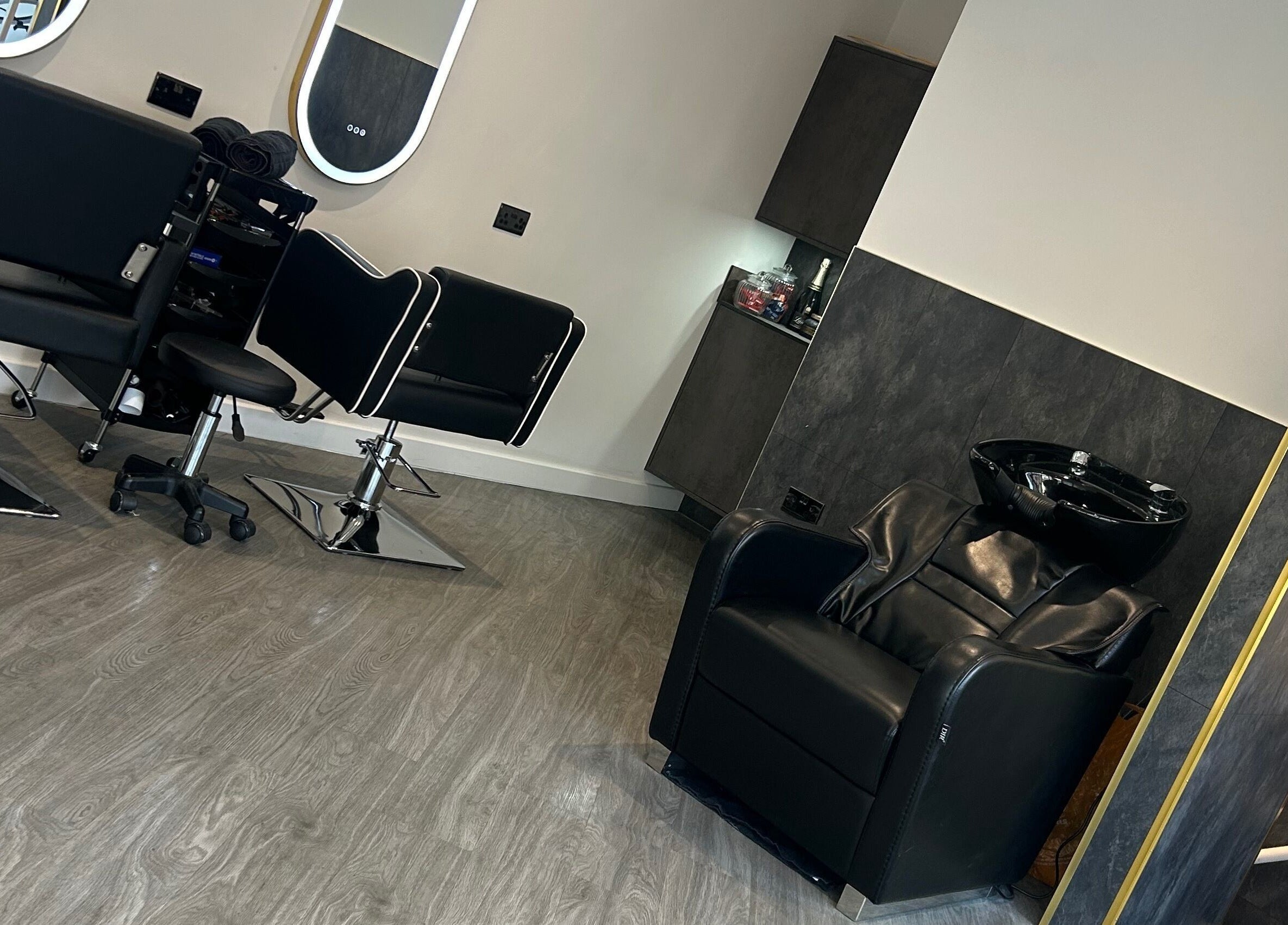 Modern salon interior at By Via, Blackpool, England, GB with stylish chairs and a hair washing station.