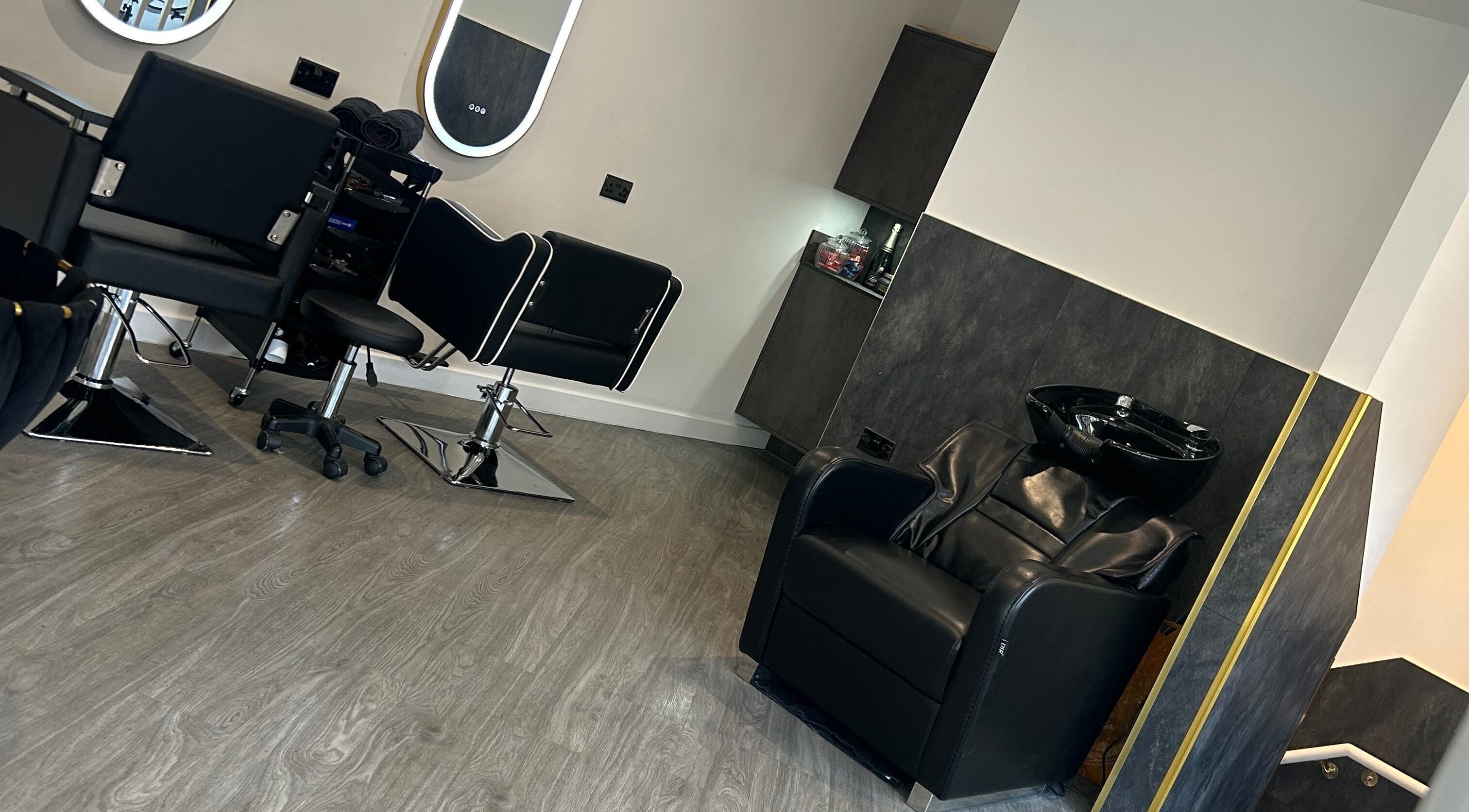 Modern salon interior at By Via, Blackpool, England, GB with stylish chairs and a hair washing station.