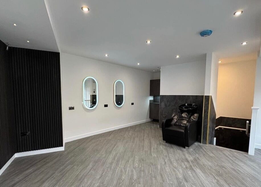 Sleek salon interior at By Via, Blackpool, England, GB featuring modern mirrors and seating.