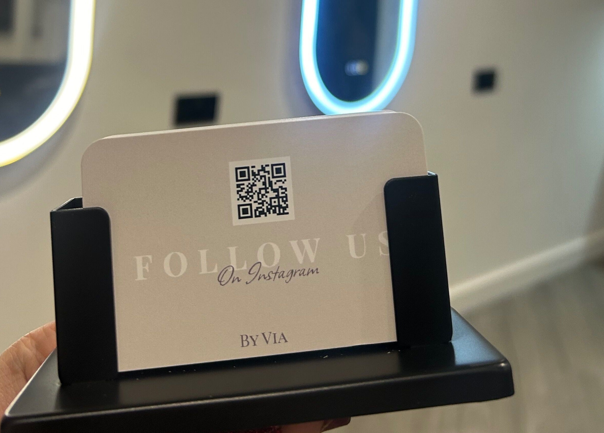 Invitation card with QR code at By Via, Blackpool, England, GB. Backdrop of illuminated mirrors adds elegance.