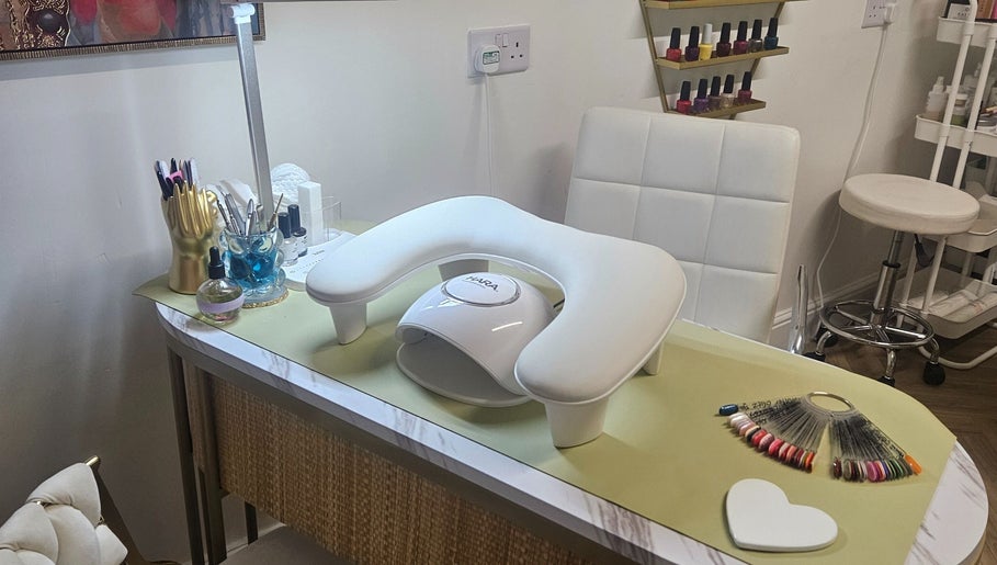Nail station setup at Sweet Escapes Beauty & Wellbeing, Rolleston-on-dove, England, featuring tools and polishes.