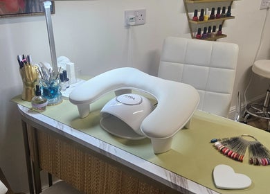 Nail station setup at Sweet Escapes Beauty & Wellbeing, Rolleston-on-dove, England, featuring tools and polishes.