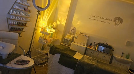 Cozy treatment room at Sweet Escapes Beauty & Wellbeing, Rolleston-on-dove, England, GB with warm lighting.