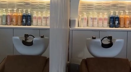 Interior of shampoo area at Katie at Outback, Dunfermline, Scotland, GB showcasing wash stations and products.