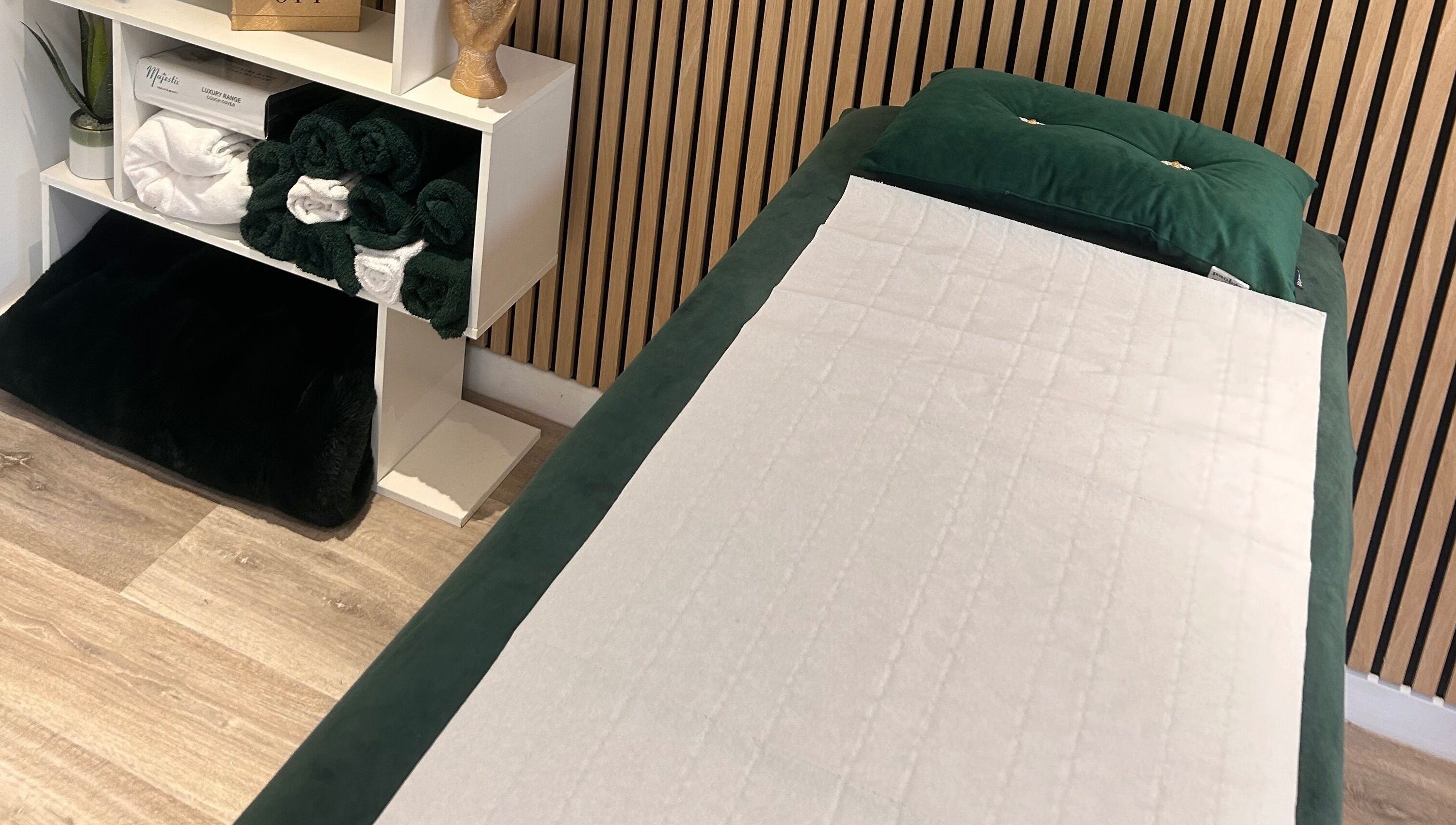 Relaxing massage table at Hollie’s Beauty, Redbourn, England, GB with neatly stacked towels.