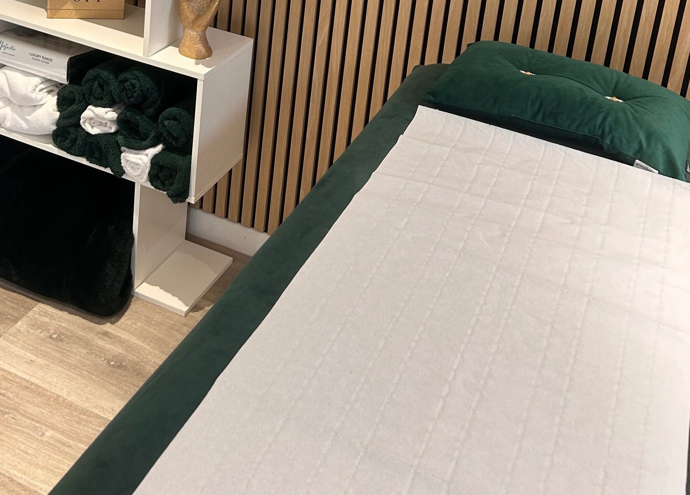 Relaxing massage table at Hollie’s Beauty, Redbourn, England, GB with neatly stacked towels.