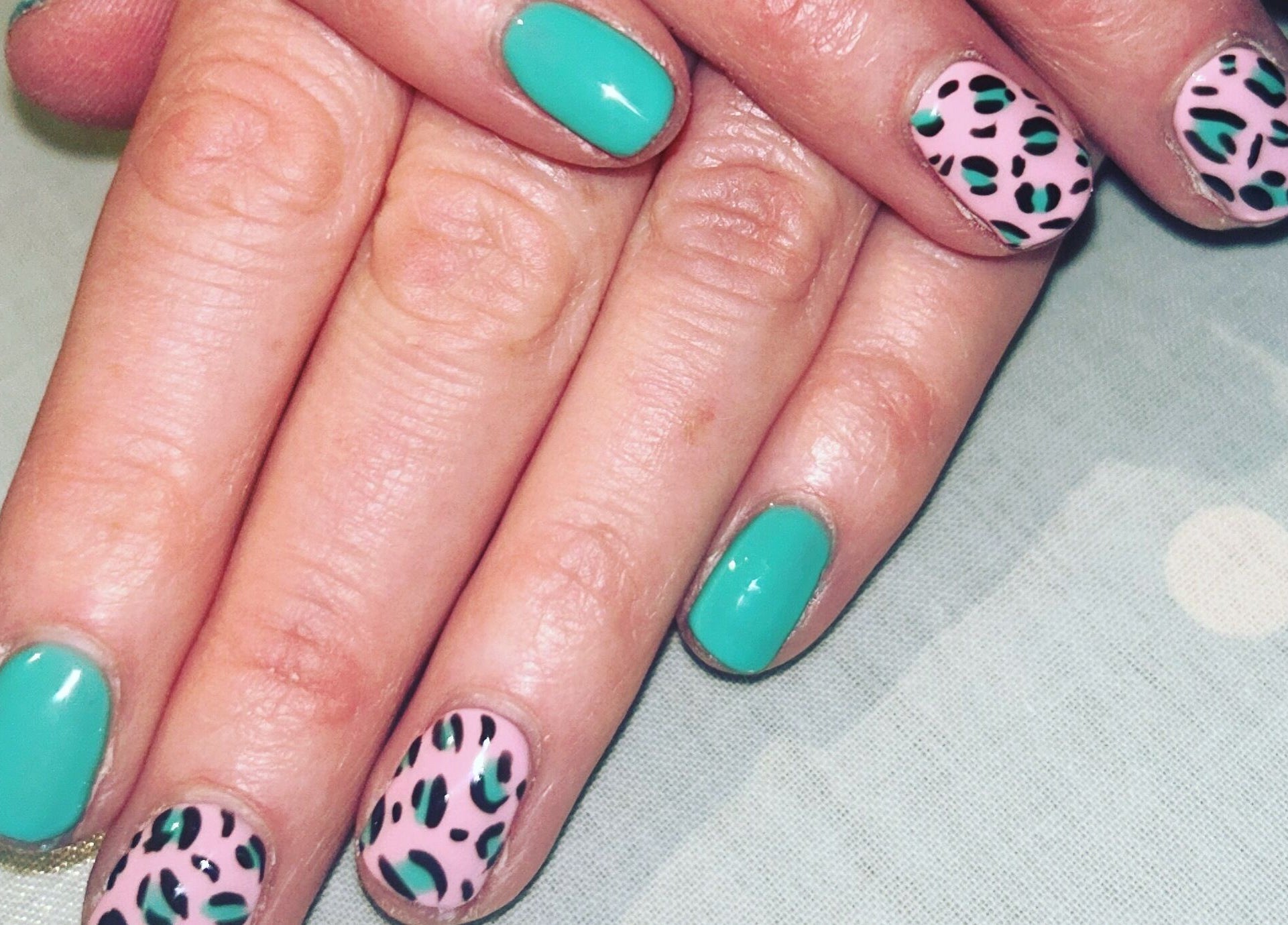 Stylish green and leopard nail art at Hollie's Beauty, Redbourn, England, GB.