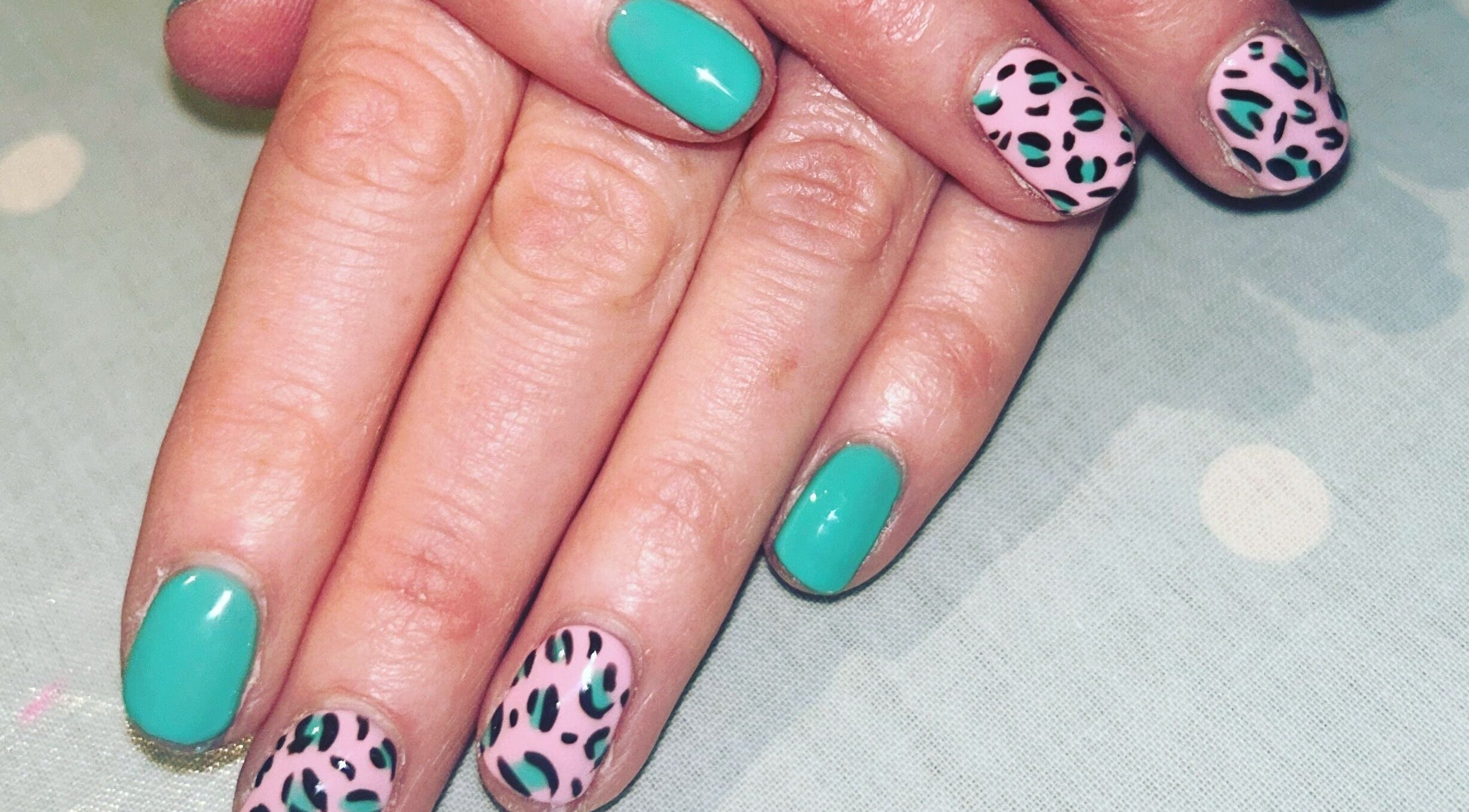 Stylish green and leopard nail art at Hollie's Beauty, Redbourn, England, GB.